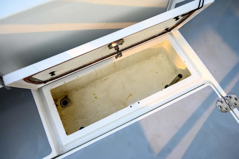 Slide: The Image of Open storage compartment on 2019 Targa 35 boat, showcasing interior space and drainage. - 57