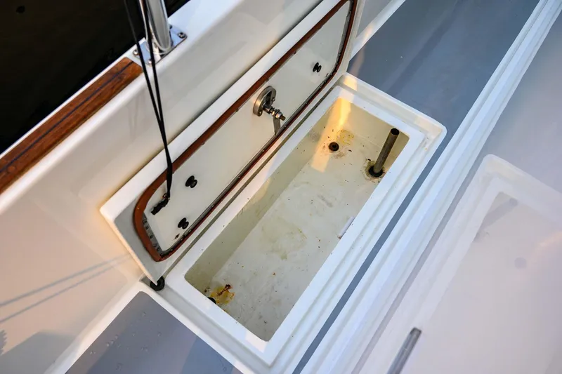 Slide: The Image of Open storage compartment on 2019 Targa 35 boat, featuring a clean, white interior. - 58