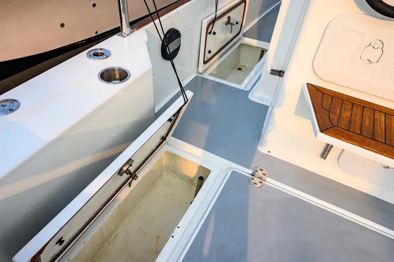 Slide: The Image of 2019 Targa 35 boat interior with open storage compartments and wooden seating. - 59