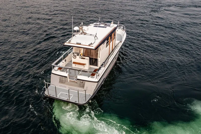 Slide: The Image of 2019 Targa 35 boat cruising on open water, aerial view. - 6