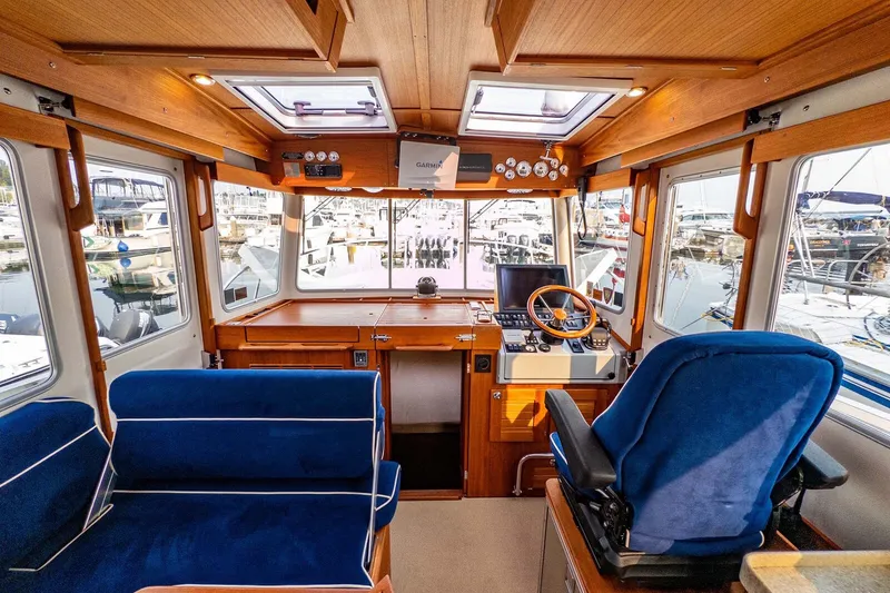 Slide: The Image of Interior of 2019 Targa 35 boat with blue seating and wooden dashboard. - 9