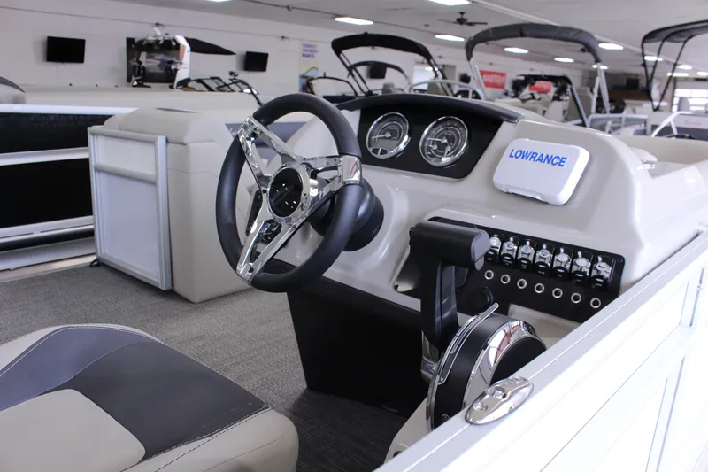 Slide: The Image of 2024 Barletta Aria 22CC boat interior with steering wheel and control panel. - 5