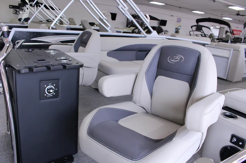 Slide: The Image of 2024 Barletta Aria 22CC boat interior with plush seating and control panel. - 7