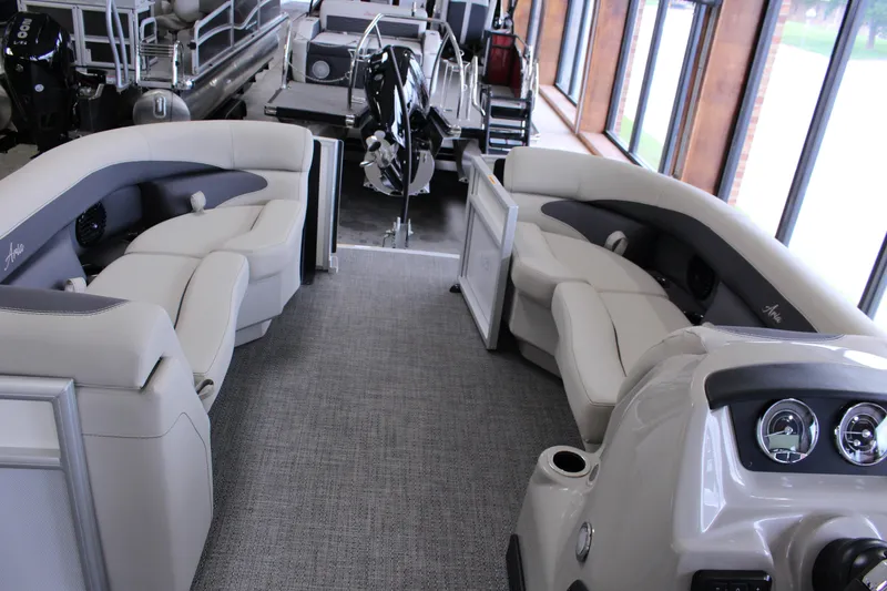 Slide: The Image of 2024 Barletta Aria 22CC pontoon boat interior with plush seating and modern dashboard. - 9