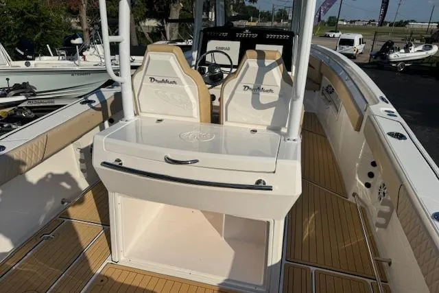 Slide: The Image of 2025 Drakkar 280CC boat interior with seating and console, featuring sleek design and wood accents. - 10