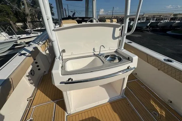 Slide: The Image of 2025 Drakkar 280CC boat interior with sink and storage area. - 12