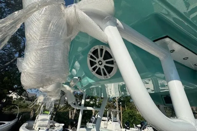 Slide: The Image of 2025 Drakkar 280CC boat with teal hull, wrapped components, and visible speaker system. - 13