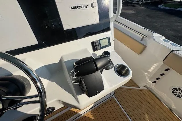 Slide: The Image of Control panel of 2025 Drakkar 280CC boat with Mercury throttle and steering wheel. - 18
