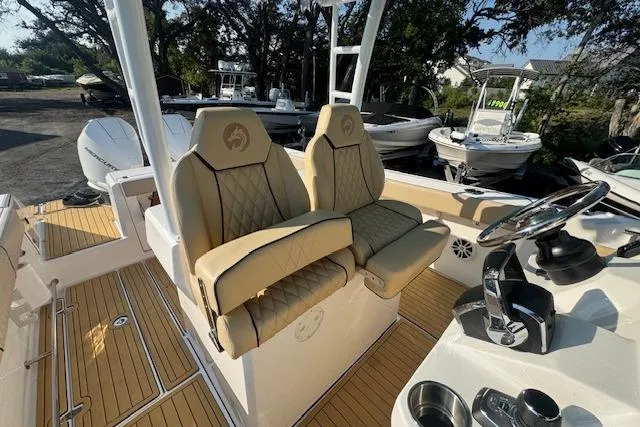 Slide: The Image of 2025 Drakkar 280CC boat interior with luxurious seating and modern steering console. - 19