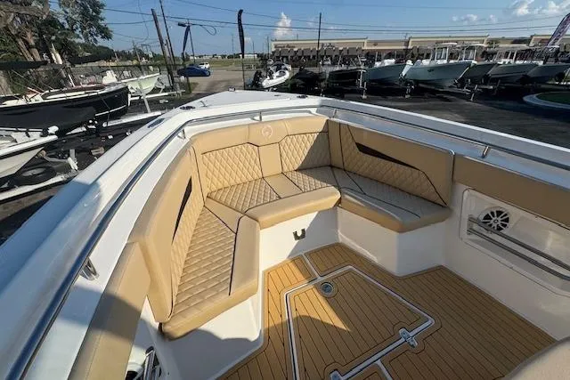Slide: The Image of 2025 Drakkar 280CC boat interior with tan seating and teak flooring. - 21