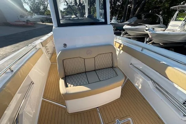 Slide: The Image of 2025 Drakkar 280CC boat interior with cushioned seating and sleek design. - 23