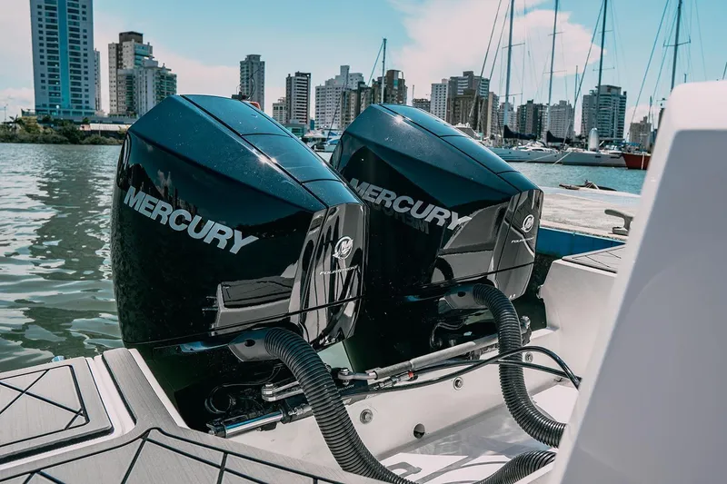 Slide: The Image of Twin Mercury outboard engines on a 2025 Drakkar 280CC boat, docked in a marina. - 27
