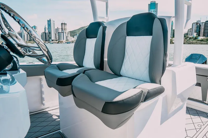 Slide: The Image of 2025 Drakkar 280CC boat interior with modern seating and cityscape background. - 29