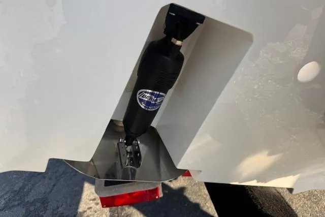 Slide: The Image of 2025 Drakkar 280CC boat detail showing hydraulic component and trailer. - 34