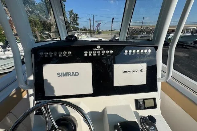 Slide: The Image of 2025 Drakkar 280CC boat dashboard with Simrad and Mercury displays. - 35