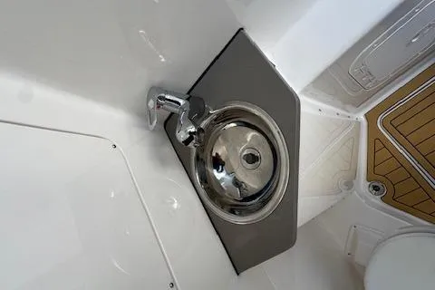 Slide: The Image of 2025 Drakkar 280CC boat interior with stainless steel sink and modern faucet. - 36