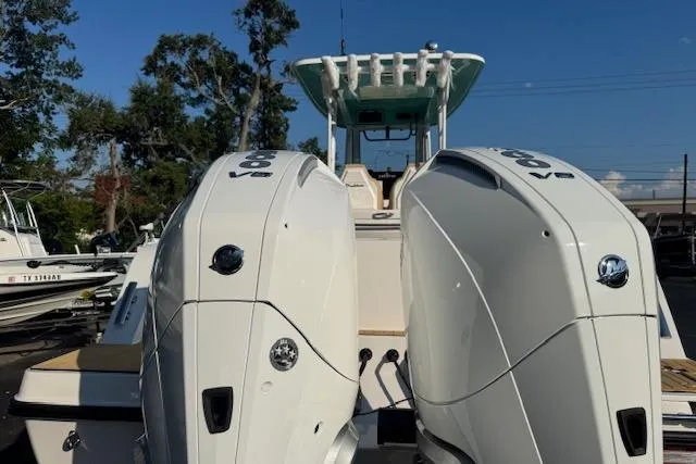 Slide: The Image of 2025 Drakkar 280CC boat with dual V8 engines, docked outdoors. - 4