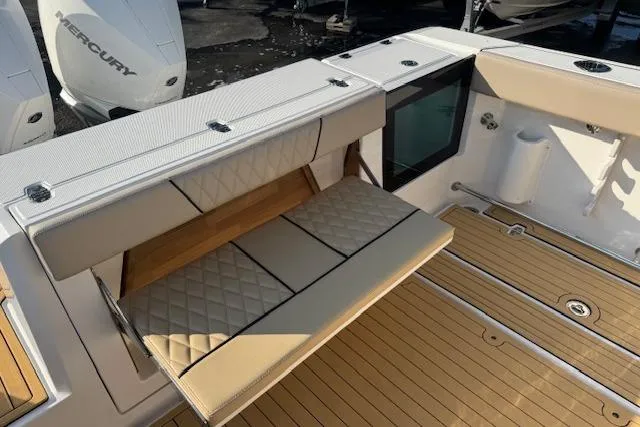 Slide: The Image of 2025 Drakkar 280CC boat with tan cushioned seating and teak flooring. - 6