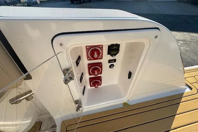 Slide: The Image of Control panel on 2025 Drakkar 280CC boat, featuring switches and dials. - 8