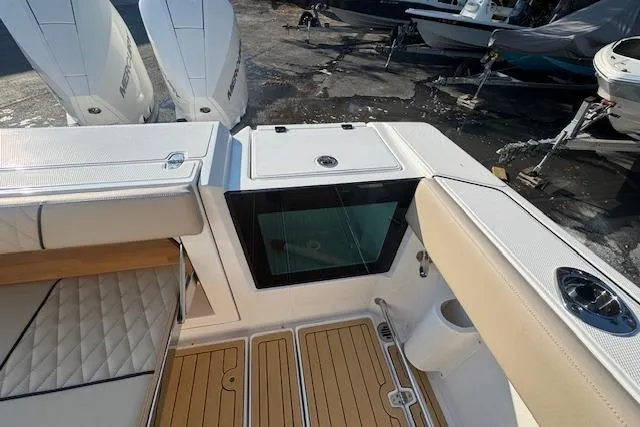 Slide: The Image of 2025 Drakkar 280CC boat interior with cushioned seating and modern design. - 9