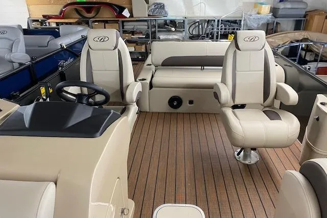 Slide: The Image of 2025 Bentley Pontoons Legacy 223 Swingback interior with luxurious seating and wood-style flooring. - 3