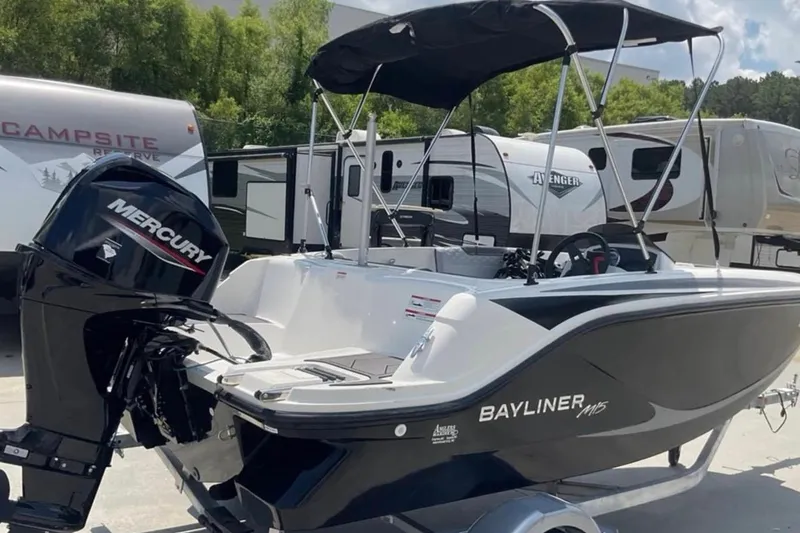 Slide: The Image of 2024 Bayliner M15 boat with Mercury engine, parked near RVs at a campsite. - 4