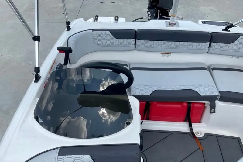 Slide: The Image of 2024 Bayliner M15 boat interior with seating and steering wheel, featuring modern design elements. - 5