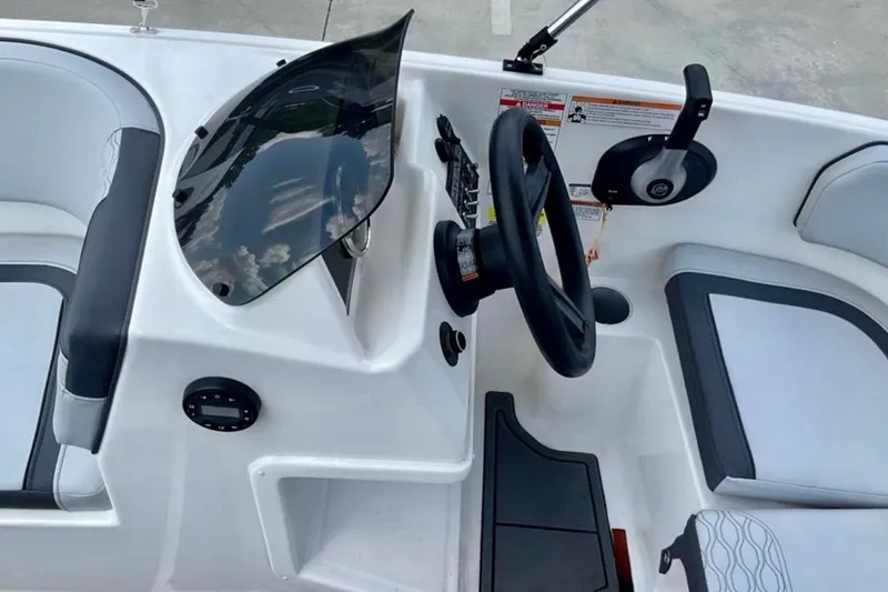 Slide: The Image of 2024 Bayliner M15 boat cockpit with steering wheel and control panel. - 6