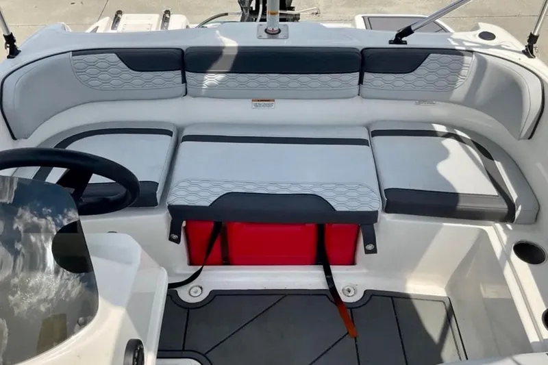 Slide: The Image of 2024 Bayliner M15 boat interior with cushioned seating and steering wheel. - 7