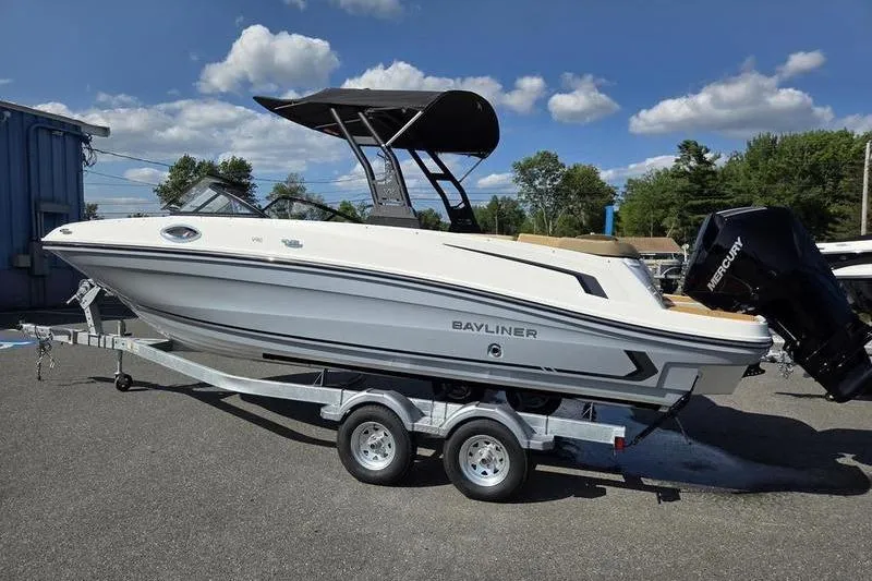 Slide: The Image of 2025 Bayliner VR6 OB boat on trailer, parked outdoors under blue sky. - 10