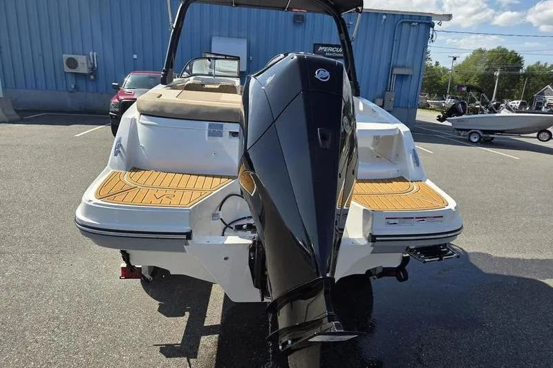 Slide: The Image of 2025 Bayliner VR6 OB boat with powerful outboard motor, parked outdoors. - 11