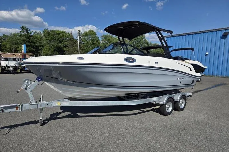 Slide: The Image of 2025 Bayliner VR6 OB boat on trailer, parked outdoors under blue sky. - 8