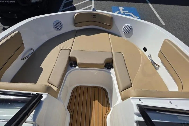 Slide: The Image of 2025 Bayliner VR6 OB boat interior with tan seating and wood accents. - 9