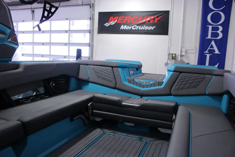 Slide: The Image of 2023 Nautique G25 boat interior with sleek seating and modern design in showroom. - 10