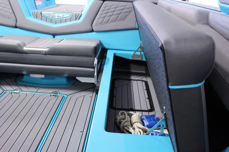Slide: The Image of 2023 Nautique G25 boat interior with open storage compartment, showcasing ropes and accessories. - 12