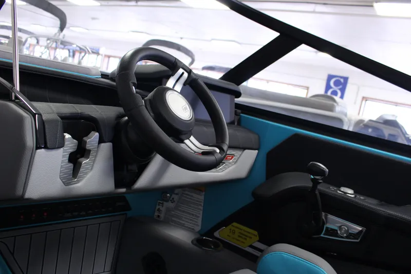 Slide: The Image of 2023 Nautique G25 boat interior with modern steering wheel and dashboard design. - 5
