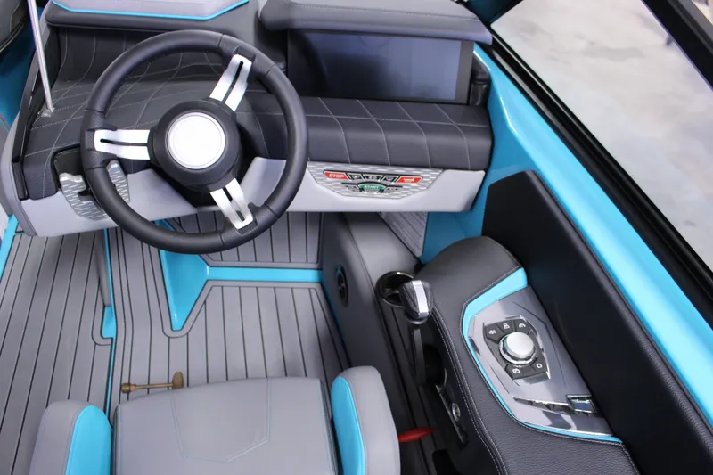 Slide: The Image of 2023 Nautique G25 boat interior with modern steering wheel and control panel. - 6