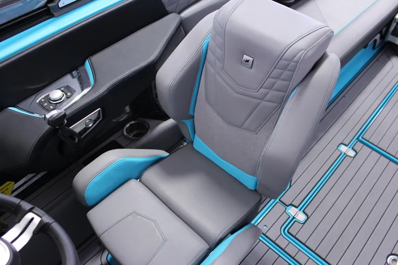 Slide: The Image of 2023 Nautique G25 interior with gray and blue seating, modern controls, and sleek design. - 8