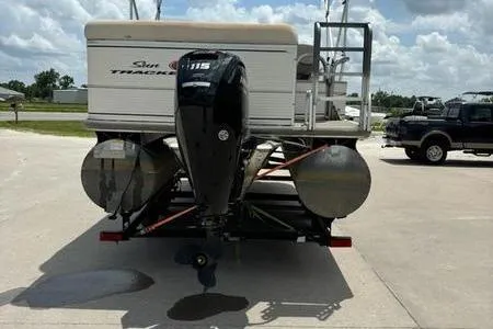 Slide: The Image of 2005 Sun Tracker PB 22 R pontoon boat with outboard motor, parked on a trailer. - 5