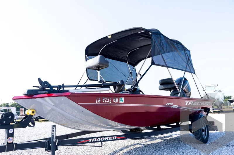 Slide: The Image of 2022 Tracker Pro 170 boat with canopy on trailer, displayed outdoors. - 10