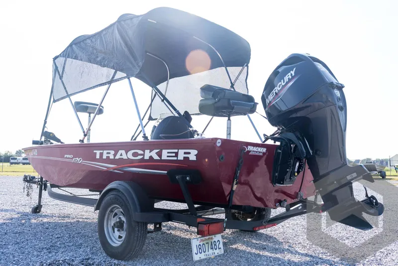 Slide: The Image of 2022 Tracker Pro 170 boat with Mercury engine on trailer, parked outdoors. - 11