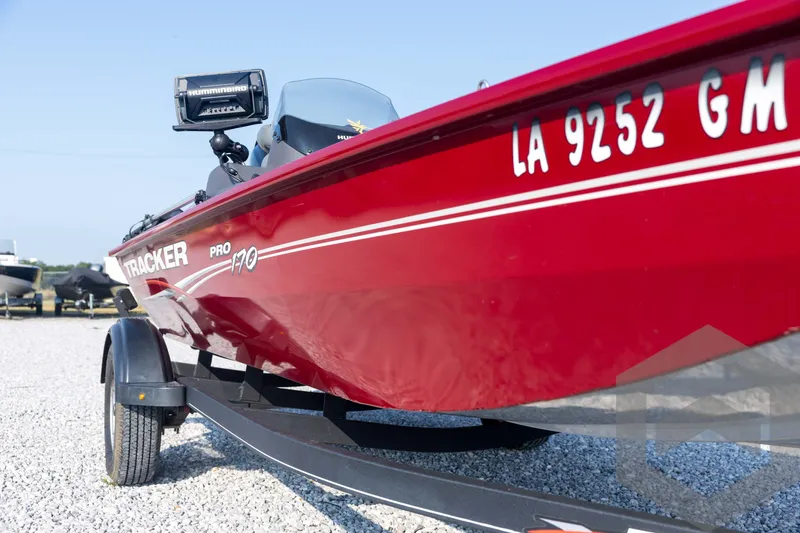 Slide: The Image of Red 2022 Tracker Pro 170 boat on trailer, featuring Humminbird electronics. - 16