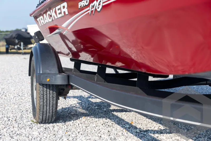 Slide: The Image of Red 2022 Tracker Pro 170 boat on trailer, parked on gravel. - 17