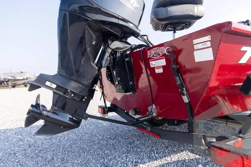 Slide: The Image of 2022 Tracker Pro 170 boat with outboard motor on gravel surface. - 20