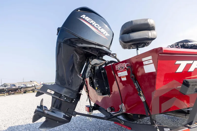 Slide: The Image of 2022 Tracker Pro 170 boat with Mercury outboard motor, red hull, and dual seats. - 22
