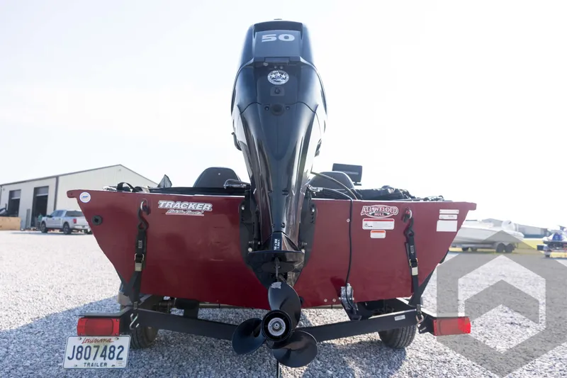 Slide: The Image of 2022 Tracker Pro 170 boat with outboard motor, parked on gravel lot. - 24