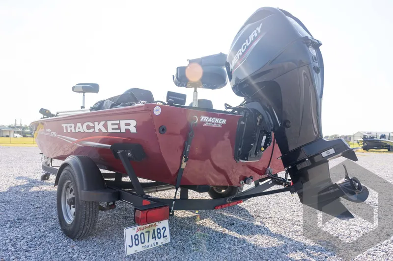 Slide: The Image of 2022 Tracker Pro 170 boat with Mercury engine on a trailer, parked on gravel. - 26