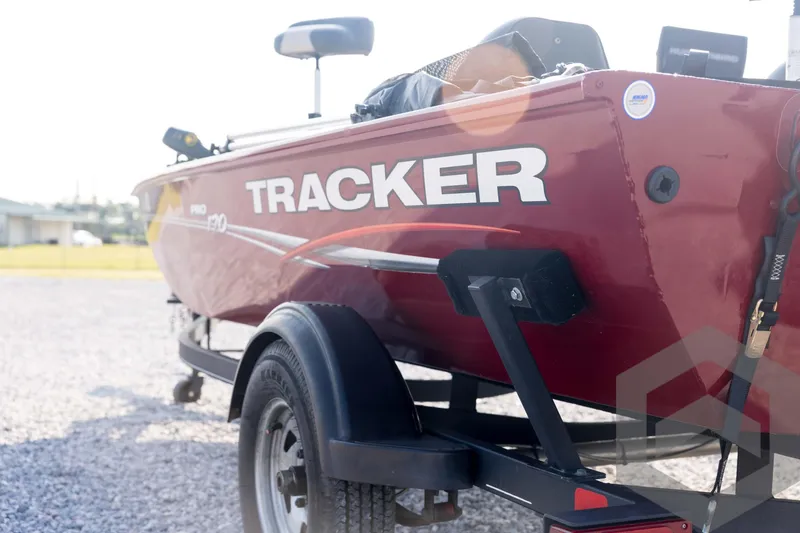 Slide: The Image of 2022 Tracker Pro 170 boat on trailer, red exterior, parked on gravel. - 27