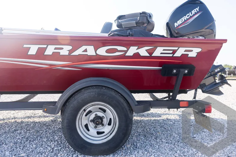 Slide: The Image of 2022 Tracker Pro 170 boat with Mercury engine on a gravel surface. - 30