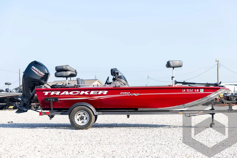 Slide: The Image of 2022 Tracker Pro 170 boat in red, side view on a trailer, with Mercury outboard motor. - 4